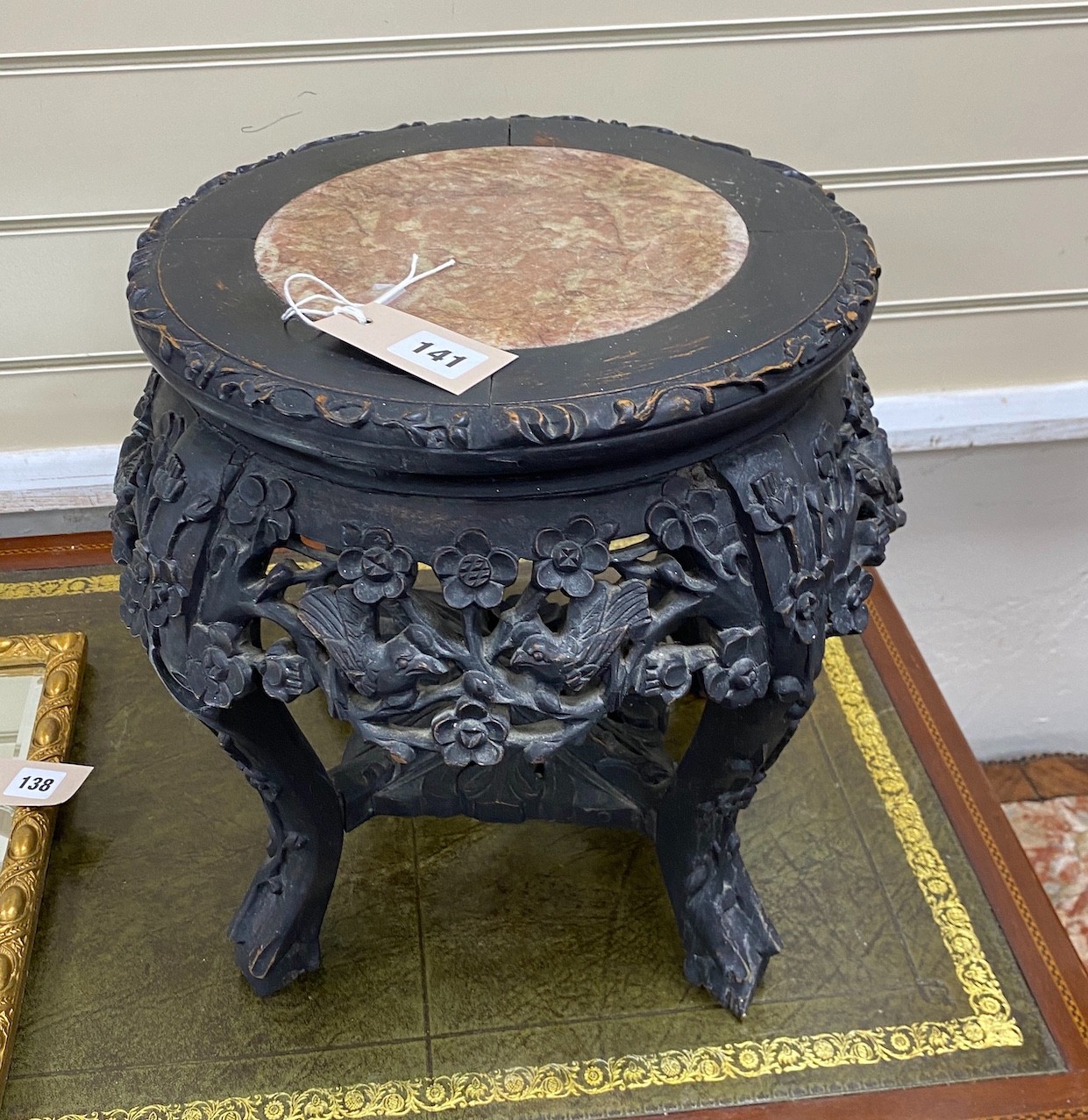 A Chinese circular carved hardwood marble topped jardiniere stand, diameter 38cm, height 35cm